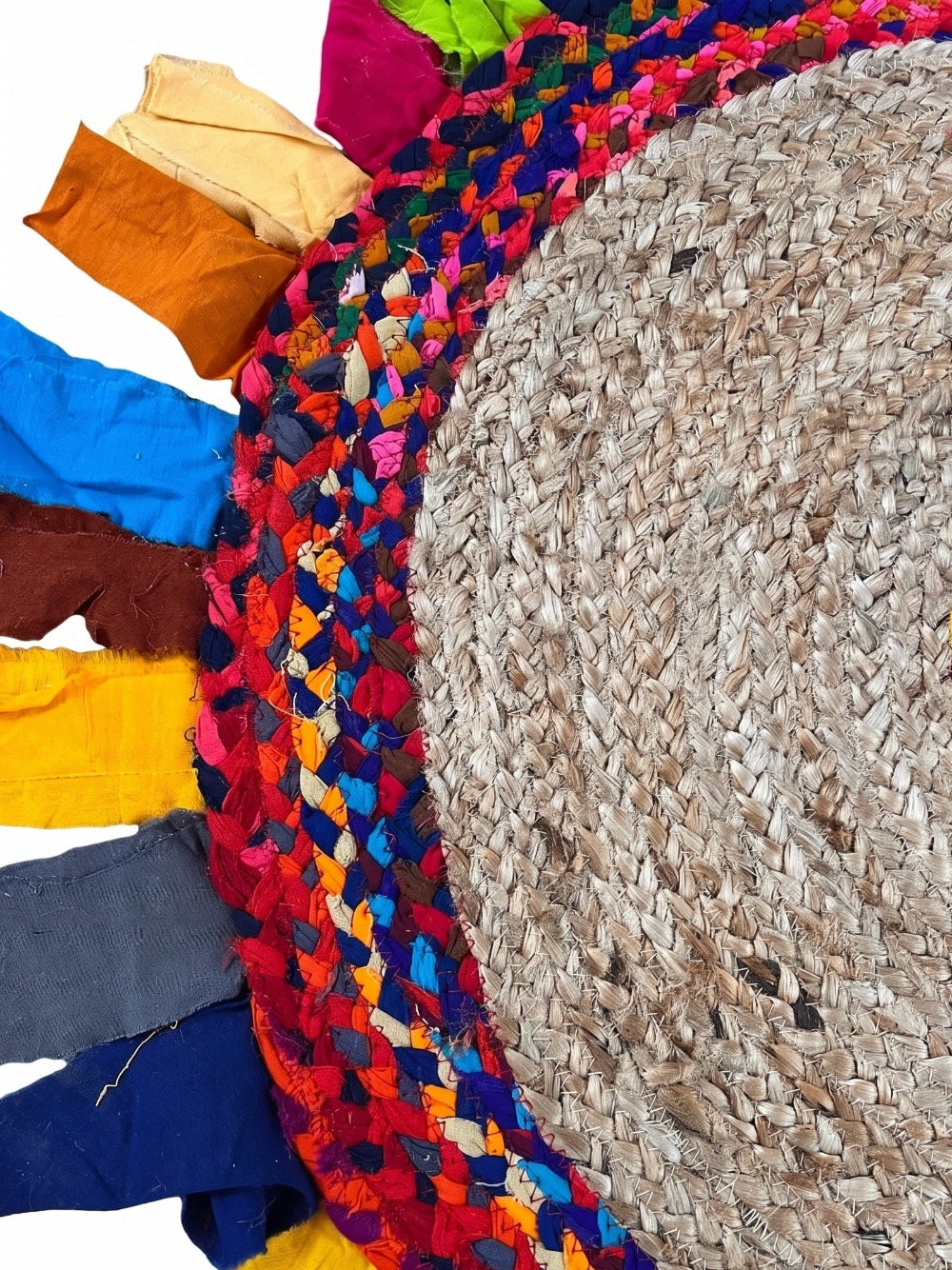 Colourful braided rug with a textured round rug underneath
