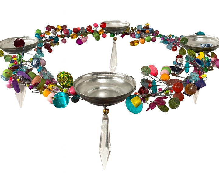 Decorative hanging with colourful beads and metal t light bowls on a white background