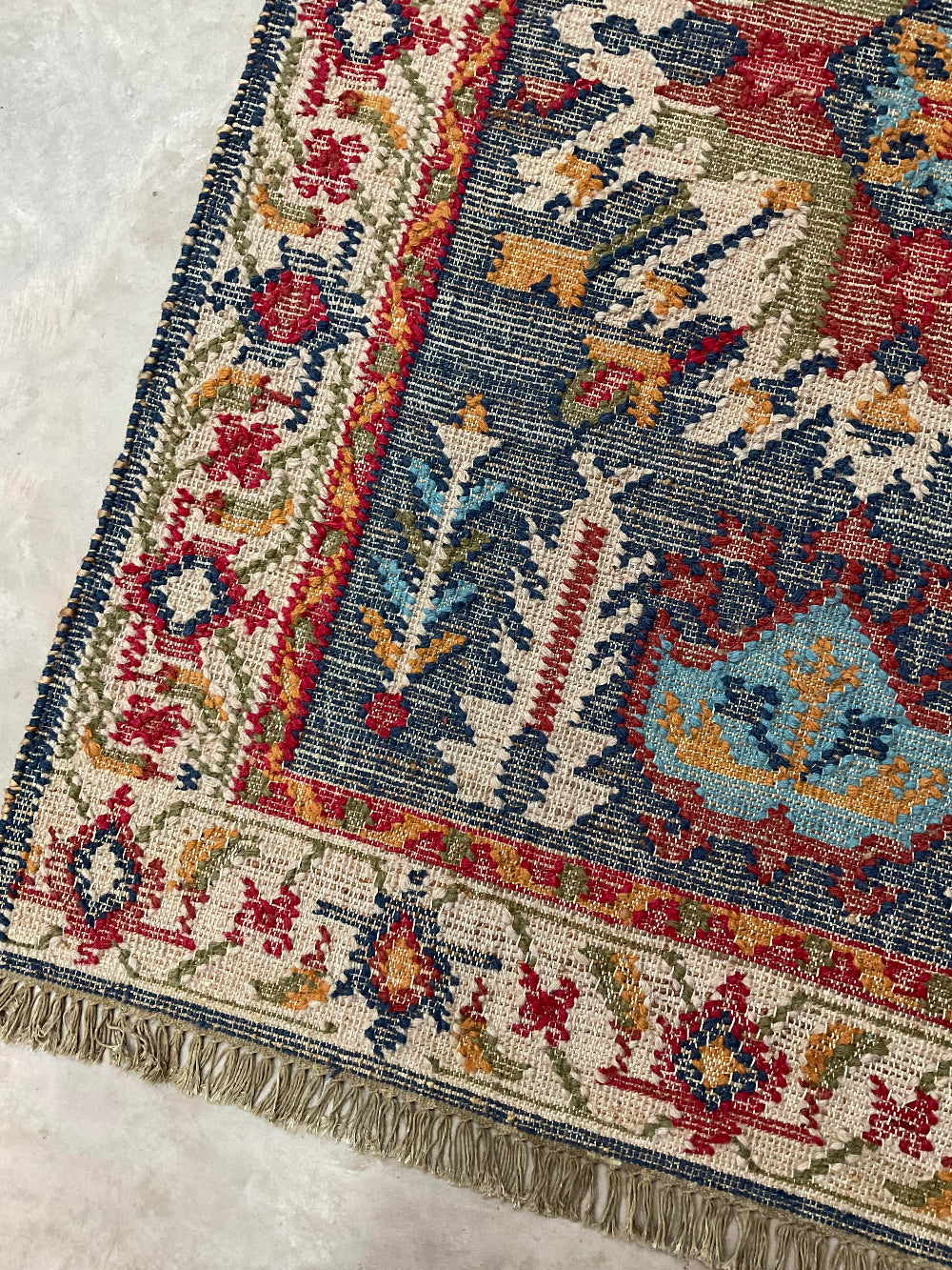 Close-up of a patterned rug with intricate designs on a textured surface