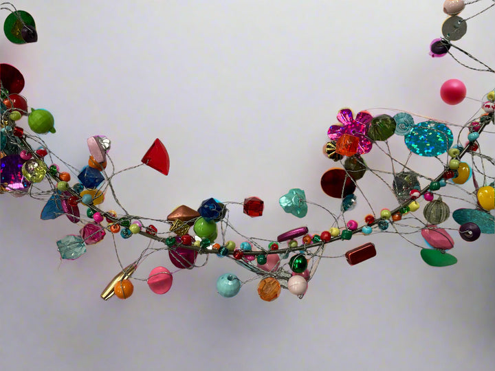 Colorful beaded garland with beaded flowers on a white background