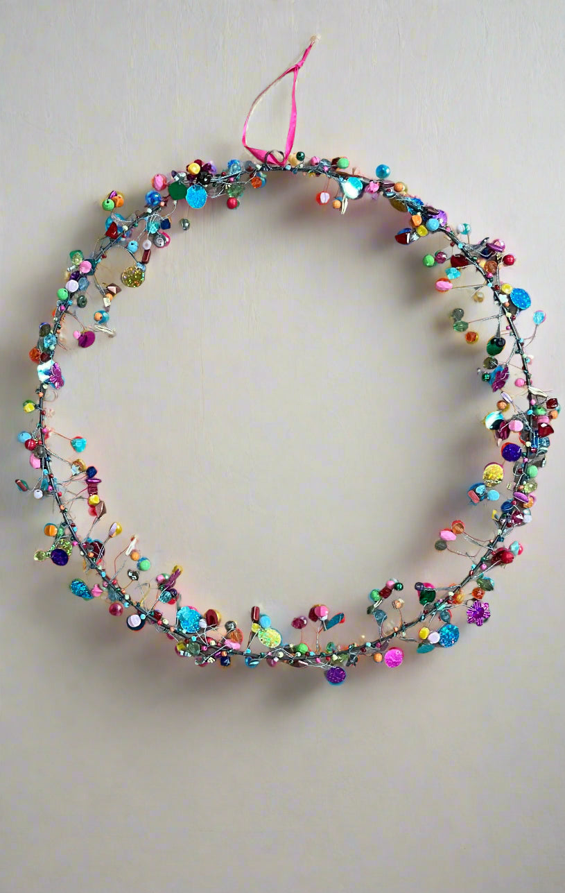 Multicolored beaded decoration on a plain background