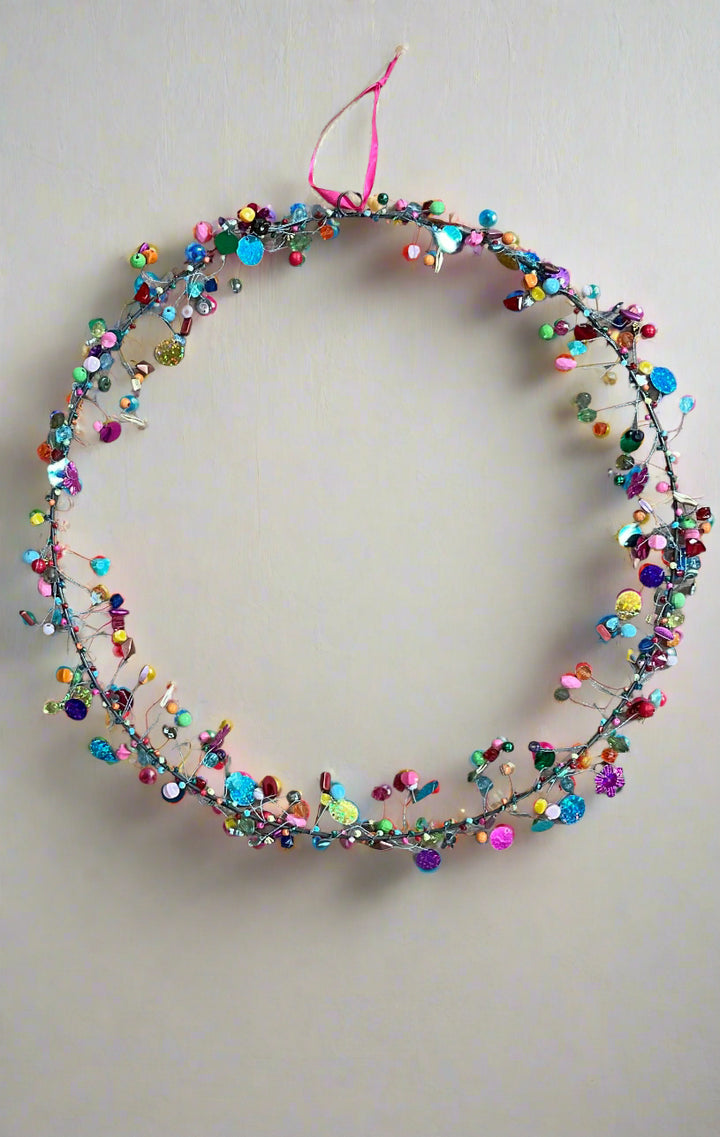 Multicolored beaded decoration on a plain background