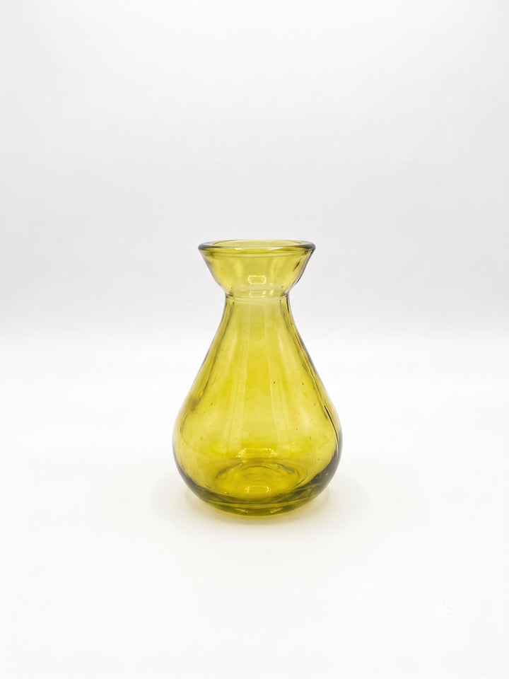 A translucent mustard glass vase with a flared rim and bulbous base, photographed against a seamless white background.