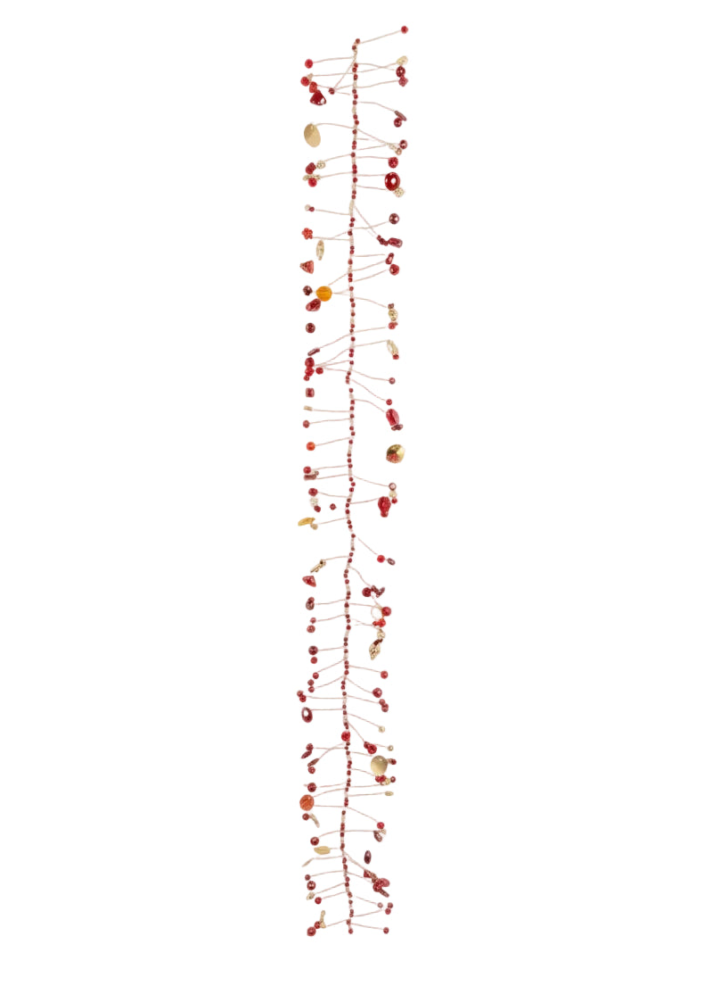 A long, narrow decorative garland or wall hanging made of many thin red string lines with small red berries and scattered natural shell-like beads, photographed against a plain white background.