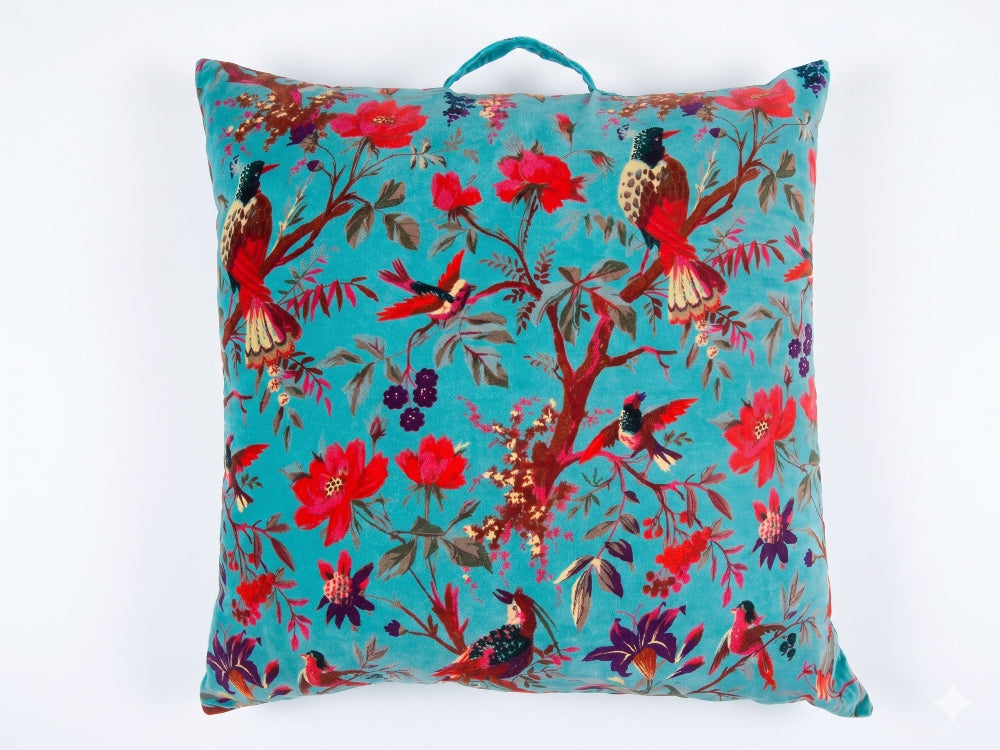 Decorative pillow with bird and floral pattern on a blue background