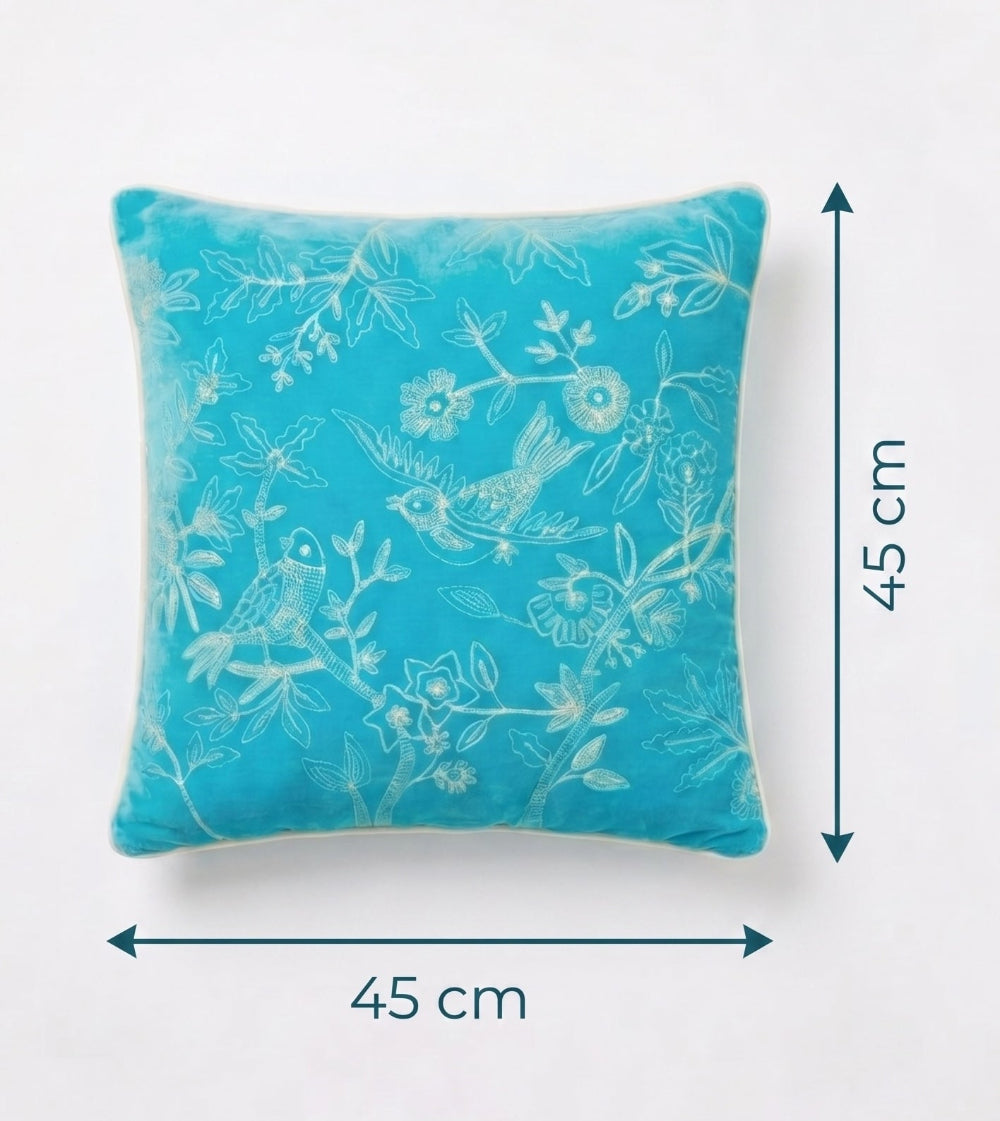 Turquoise pillow with white floral and bird pattern, shown with dimensions on a white background