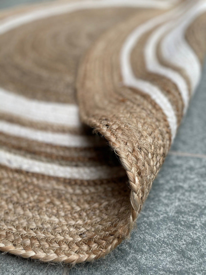 Close Up of Natural Jute Braided Rug With Cream Border